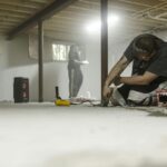 basement renovation experts fixing uneven floor and waterproofing